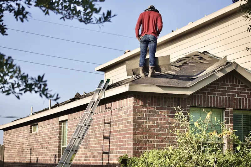 Professional roofer working on a residential roof in Island In The Sun